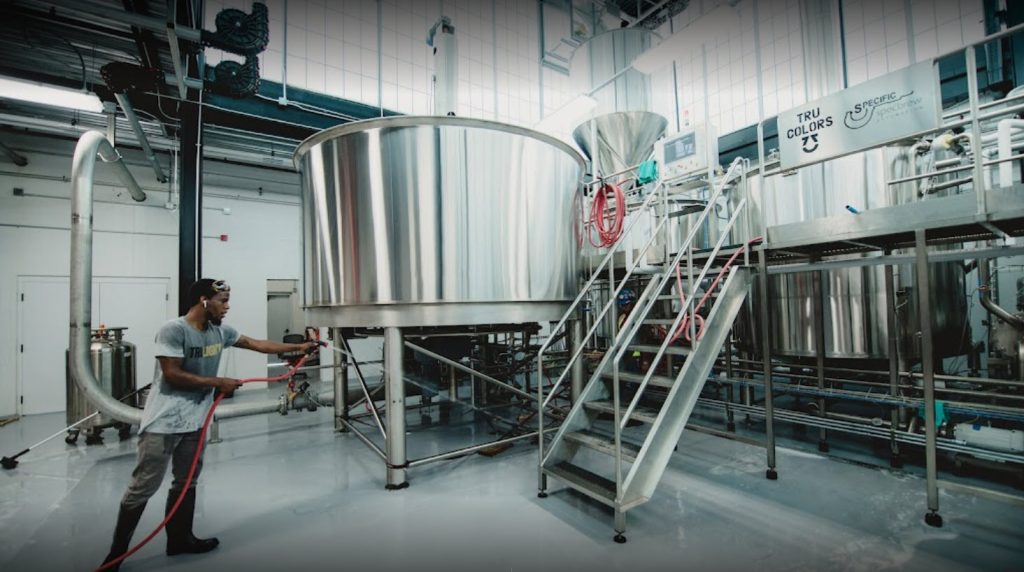 Stainless steel lauter tun with rakes and false bottom in a modern brewery brewhouse